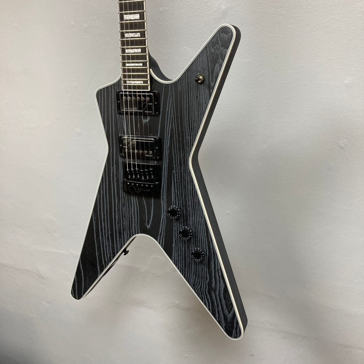 Dean Custom Run #16 ML guitar with sandblasted grey finish, displayed on a wall, highlighting its intricate string details and signature ML design.
