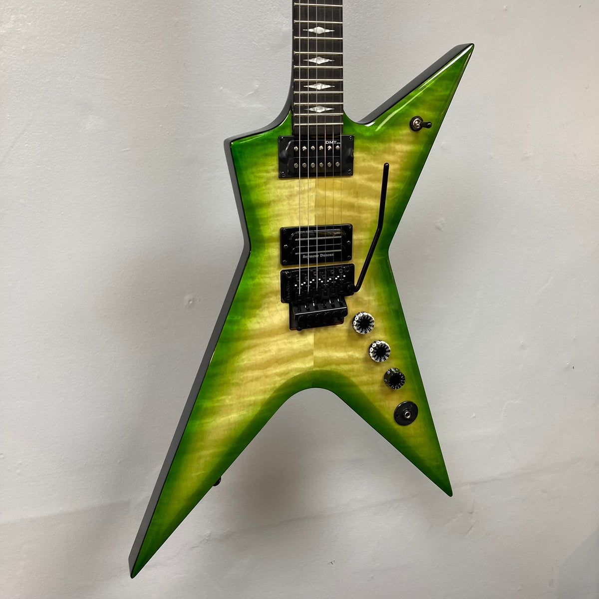 Dean Stealth Floyd FM Dime Slime electric guitar with ebony fretboard, Pearl Dime Stealth inlays, and black hardware, showcased with a hardshell case.