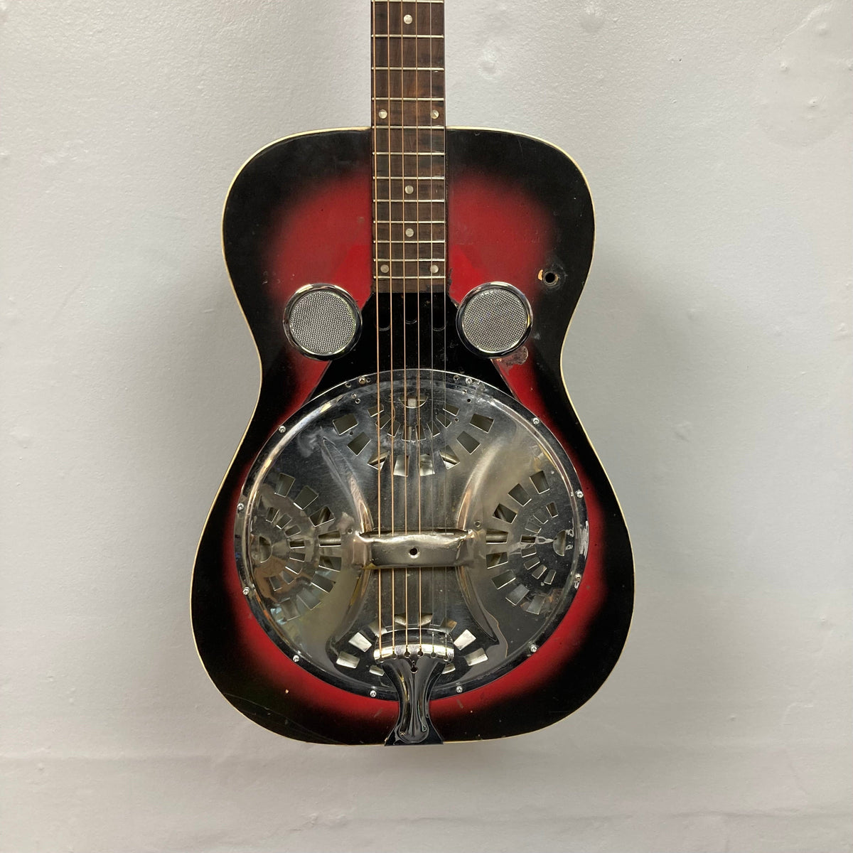 Dobro Model 60 DS Round Neck 1970s Red Burst resonator guitar with a metal cover, showing close-up details of strings and resonator.