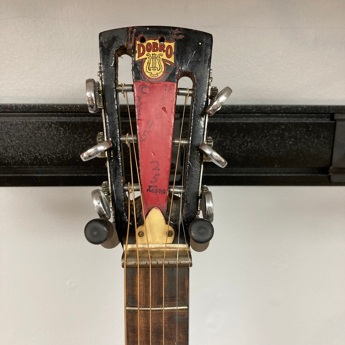 Dobro Model 60 DS Round Neck 1970s Red Burst resonator guitar, showcasing strings and neck with red burst finish, highlighting unique, well-used condition.