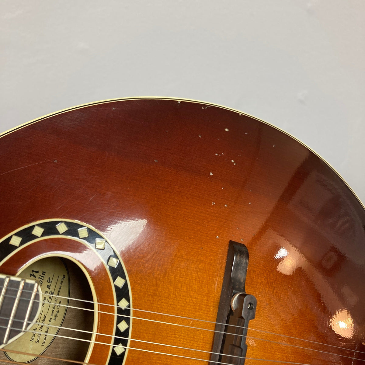 Close-up of the Eastman MD604-GB A-Style Oval-Hole Mandolin, showcasing detailed craftsmanship and strings, ideal for musicians. Comes with a protective case.
