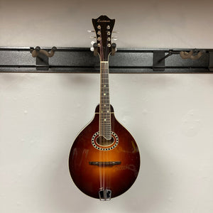 Eastman MD604-GB A-Style Oval-Hole Mandolin displayed on wall, highlighting its craftsmanship and design. Case included, perfect for musicians seeking quality instruments.