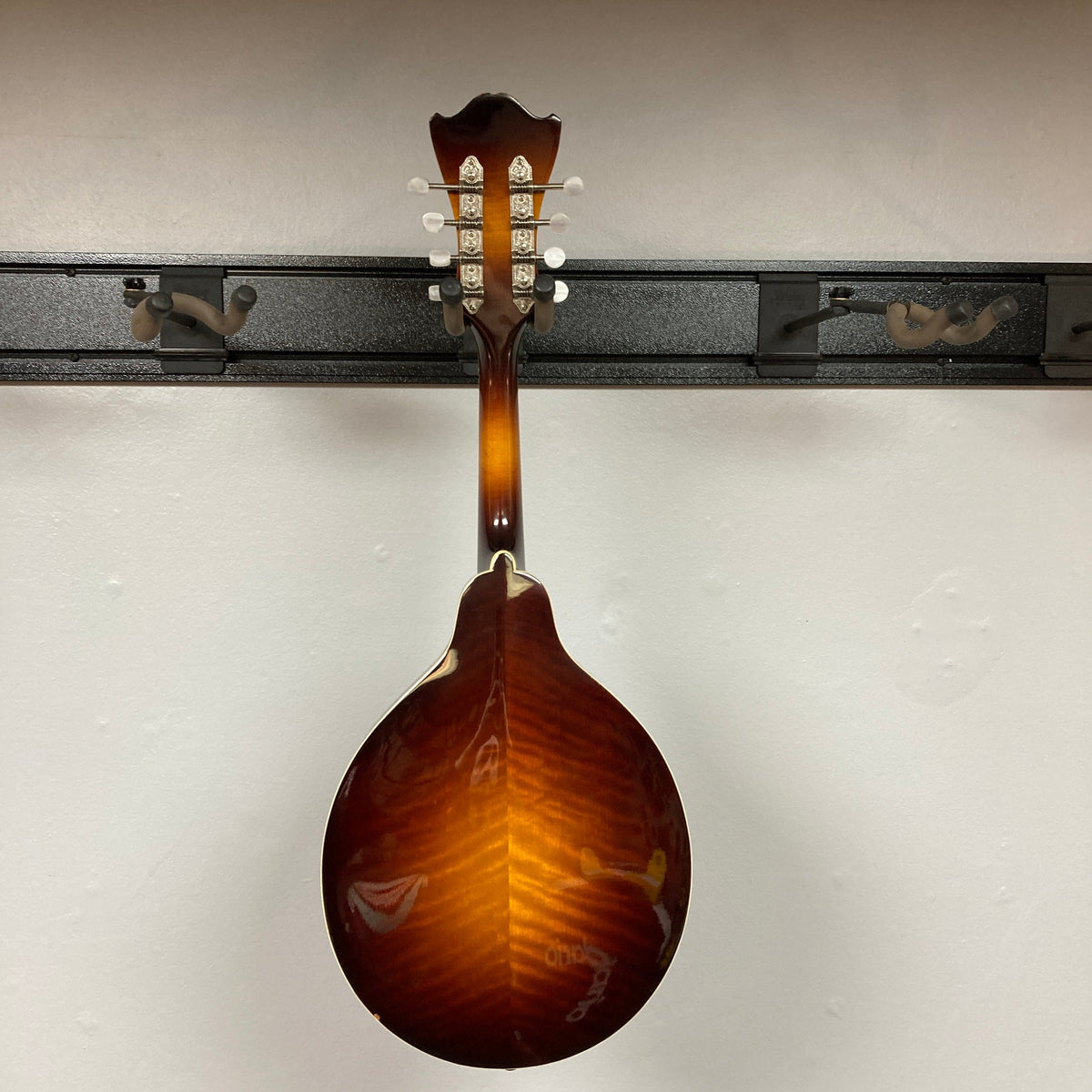 Eastman MD604-GB A-Style Oval-Hole Mandolin on display rack, showcasing its unique craftsmanship and design, ideal for musicians. Case included.