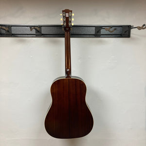 Epiphone 1942 Banner J-45 Vintage Sunburst acoustic guitar mounted on a wall with visible mahogany back and sides, showcasing its iconic design.