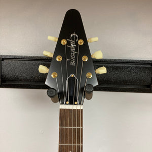 Epiphone 1958 Korina Flying V Left handed w/Case on stand, showcasing its solid Korina body and Indian laurel fretboard.