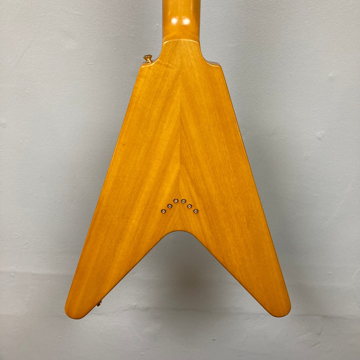 Epiphone 1958 Korina Flying V Left handed guitar, close-up of body and neck details, crafted with vintage accuracy and includes a hardshell case.