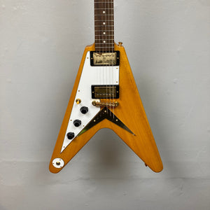 Epiphone 1958 Korina Flying V Left handed guitar on display, showcasing its solid Korina body, Indian laurel fretboard, and Gibson Burstbucker pickups.