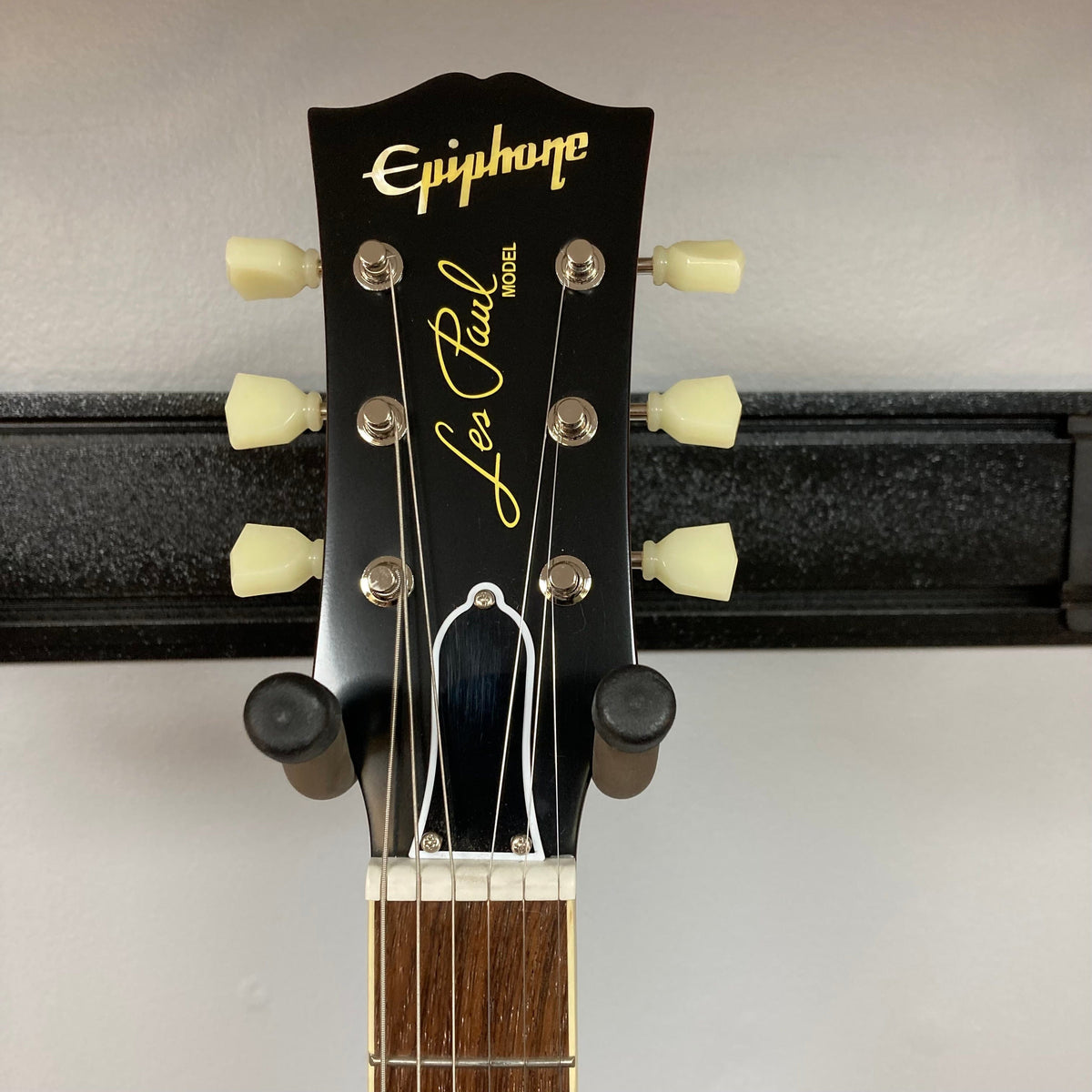 Epiphone 1959 Les Paul Standard Iced Tea on a stand, showcasing its mahogany body, maple top, and Gibson Custombucker humbucking pickups.