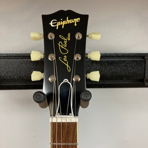 Epiphone 1959 Les Paul Standard Iced Tea on a stand, showcasing its mahogany body, maple top, and Gibson Custombucker humbucking pickups.