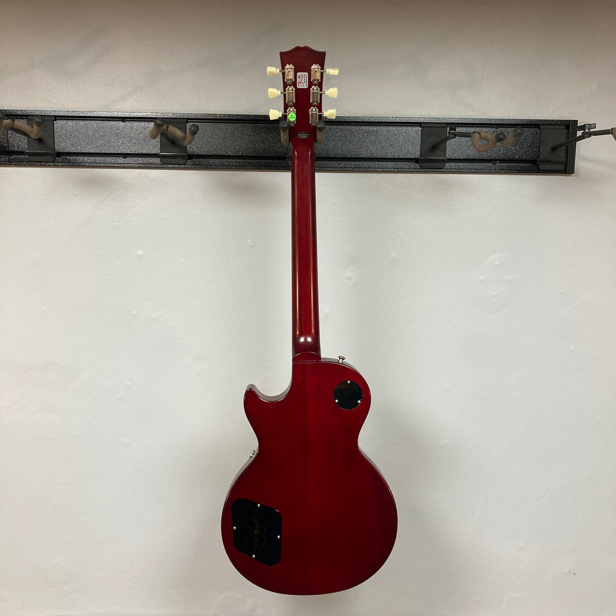 Epiphone 1959 Les Paul Standard Iced Tea guitar with mahogany body, maple top, and vintage-style hardware, displayed on a stand.