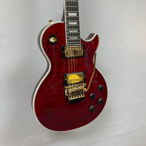 Epiphone Alex Lifeson Les Paul Custom Axcess guitar with gold hardware, displayed on a wall.