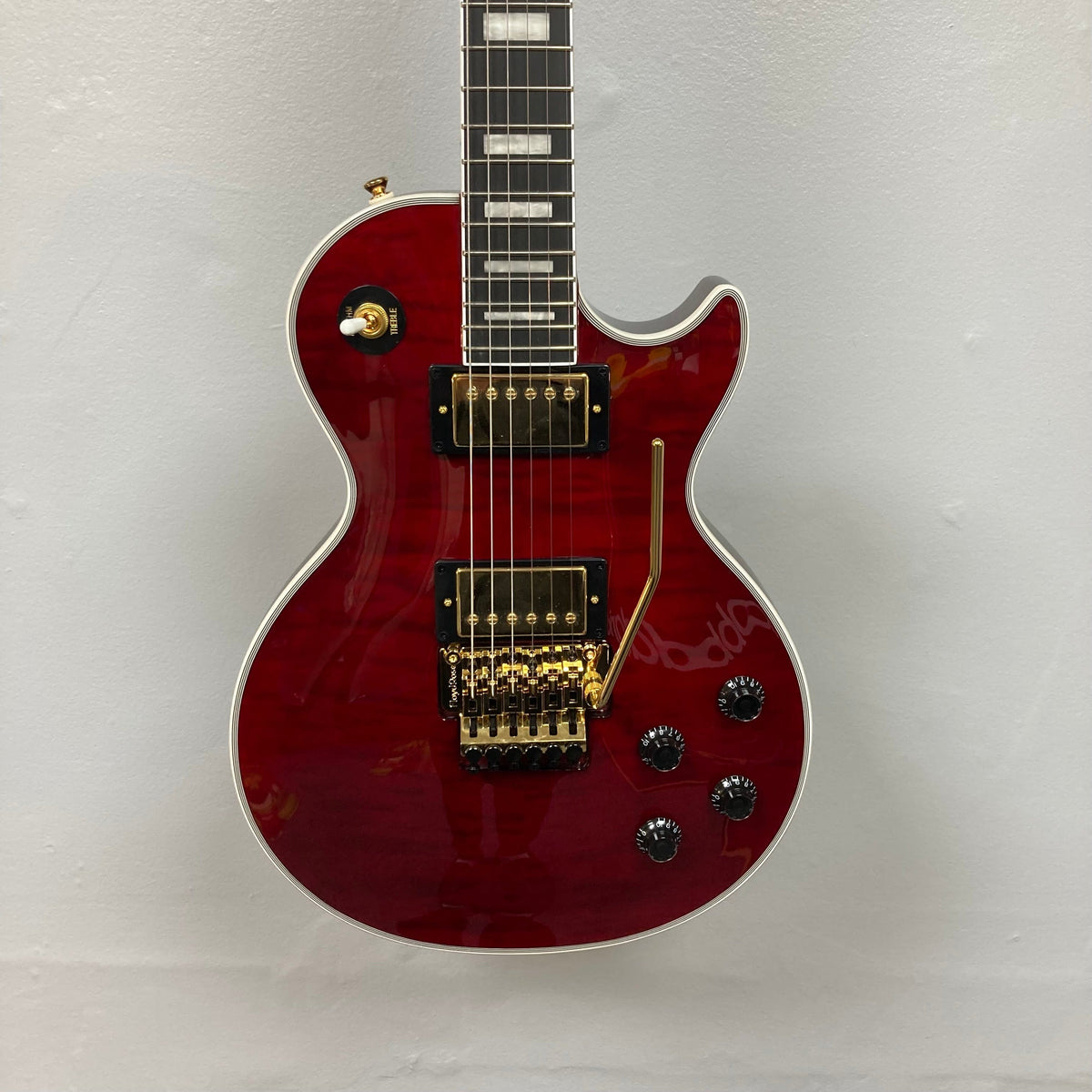 Epiphone Alex Lifeson Les Paul Custom Axcess w/Case, featuring gold hardware, Floyd Rose tremolo, and Epiphone Ceramic Pro pickups on a white background.