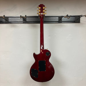 Epiphone Alex Lifeson Les Paul Custom Axcess w/Case, red electric guitar with gold hardware, displayed on a stand.