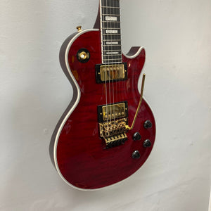 Epiphone Alex Lifeson Les Paul Custom Axcess w/Case, featuring gold hardware and Floyd Rose tremolo, displayed against a wall.