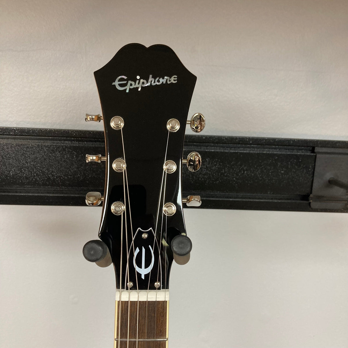 Epiphone Casino Natural guitar on a stand, featuring Dogear PRO P-90 pickups and a 5-ply maple body.