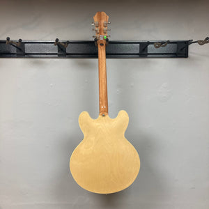 Epiphone Casino Natural guitar displayed on a wall, highlighting its hollowbody design and Dogear PRO P-90 pickups, known for its iconic rock 'n' roll heritage.