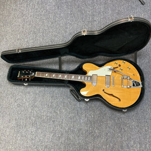 Epiphone Casino Reissue 1995 guitar in case, showcasing its hollow body and neck with parallelogram inlays, ideal for collectors and players.