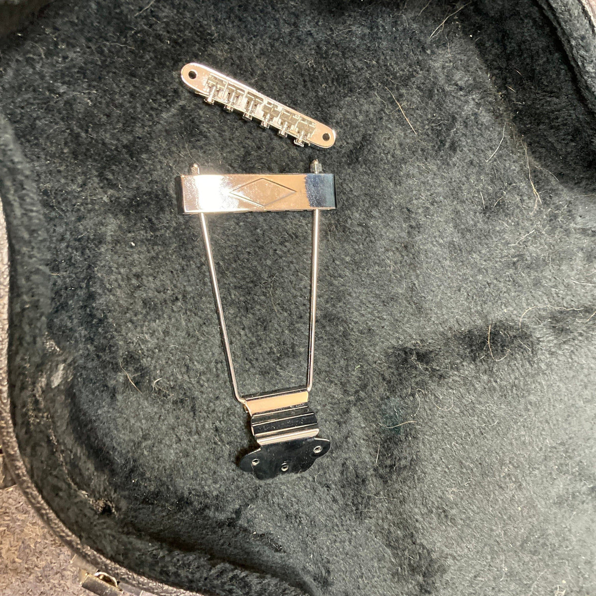 Epiphone Casino Reissue 1995 guitar with case, showcasing a metal bridge and trapeze tailpiece, highlighting its legendary craftsmanship and appeal for collectors.