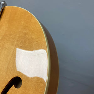 Close-up of a 1995 Epiphone Casino Reissue guitar, highlighting its hollow body and classic design, available with a case through Guitars on Main.
