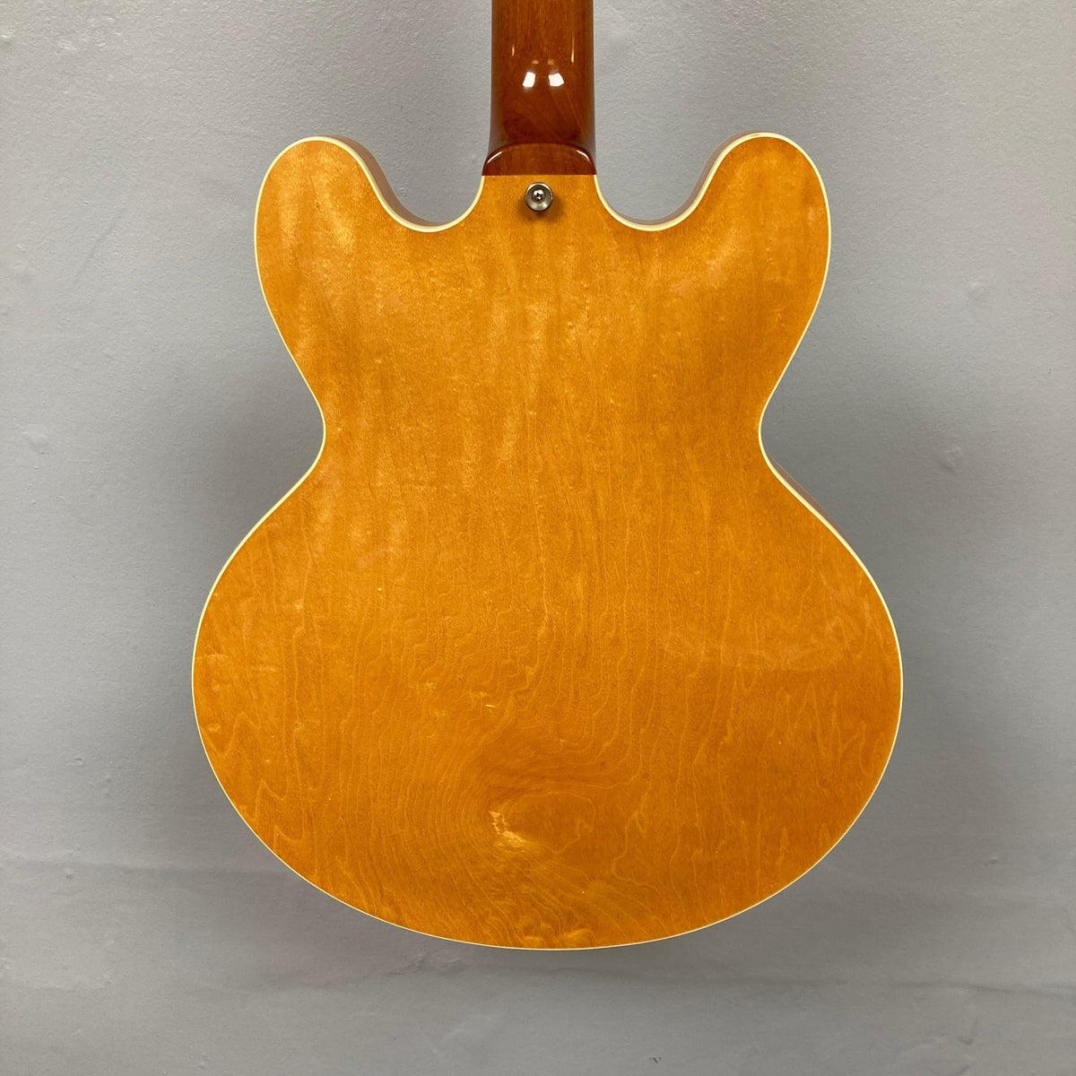 Close-up of 1995 Epiphone Casino Reissue guitar, highlighting the hollow-body design and dual P-90 pickups, a classic choice for collectors.