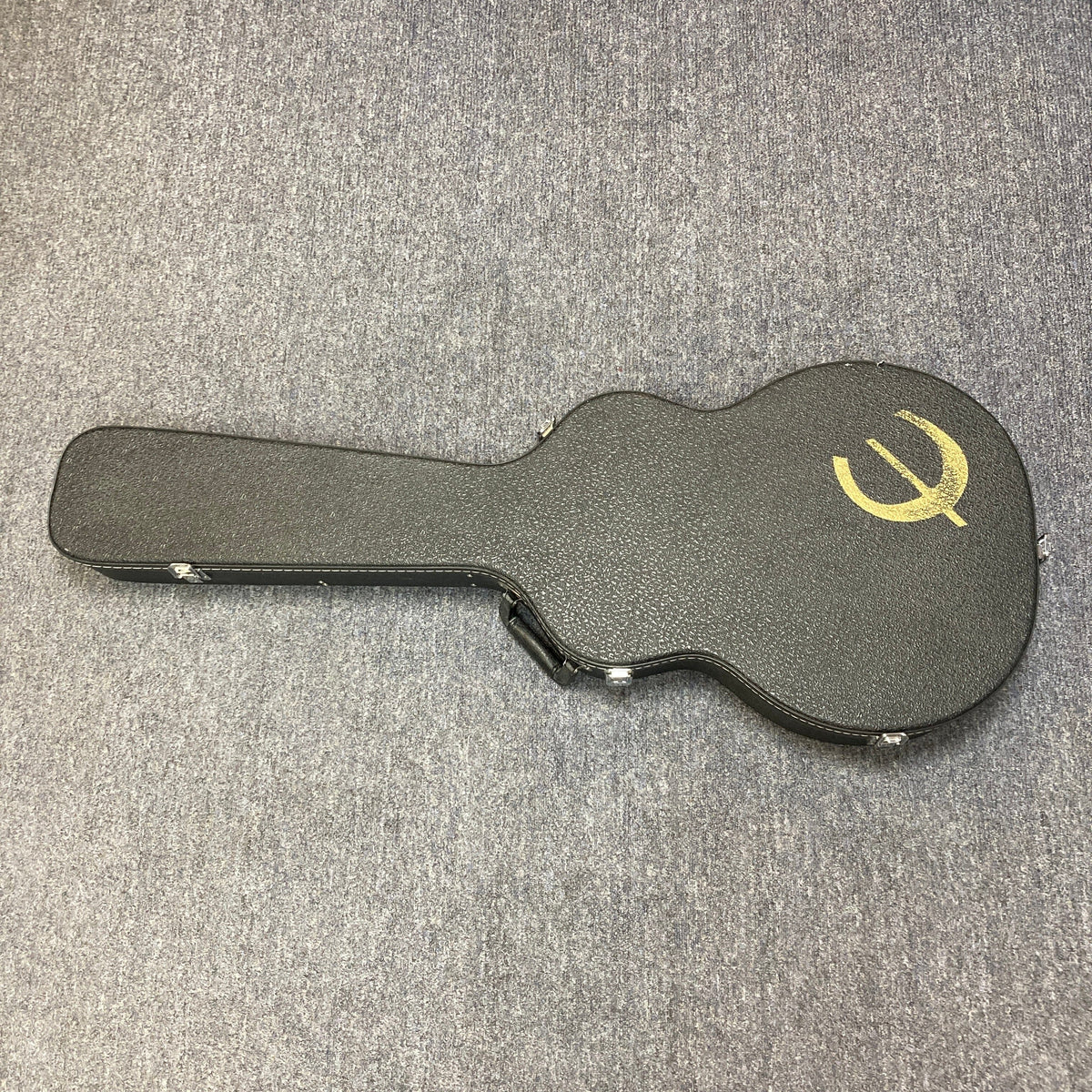 Epiphone Casino Reissue 1995 guitar in black case on grey carpet, highlighting its iconic design and craftsmanship, available via Guitars on Main consignment.