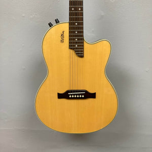 A close-up of an Epiphone Chet Atkins SST Studio Natural acoustic-electric guitar (Korea, used consignment) with a light wood body, dark bridge, two upper-side control knobs, and piezo pickup, set on a plain light gray background.
