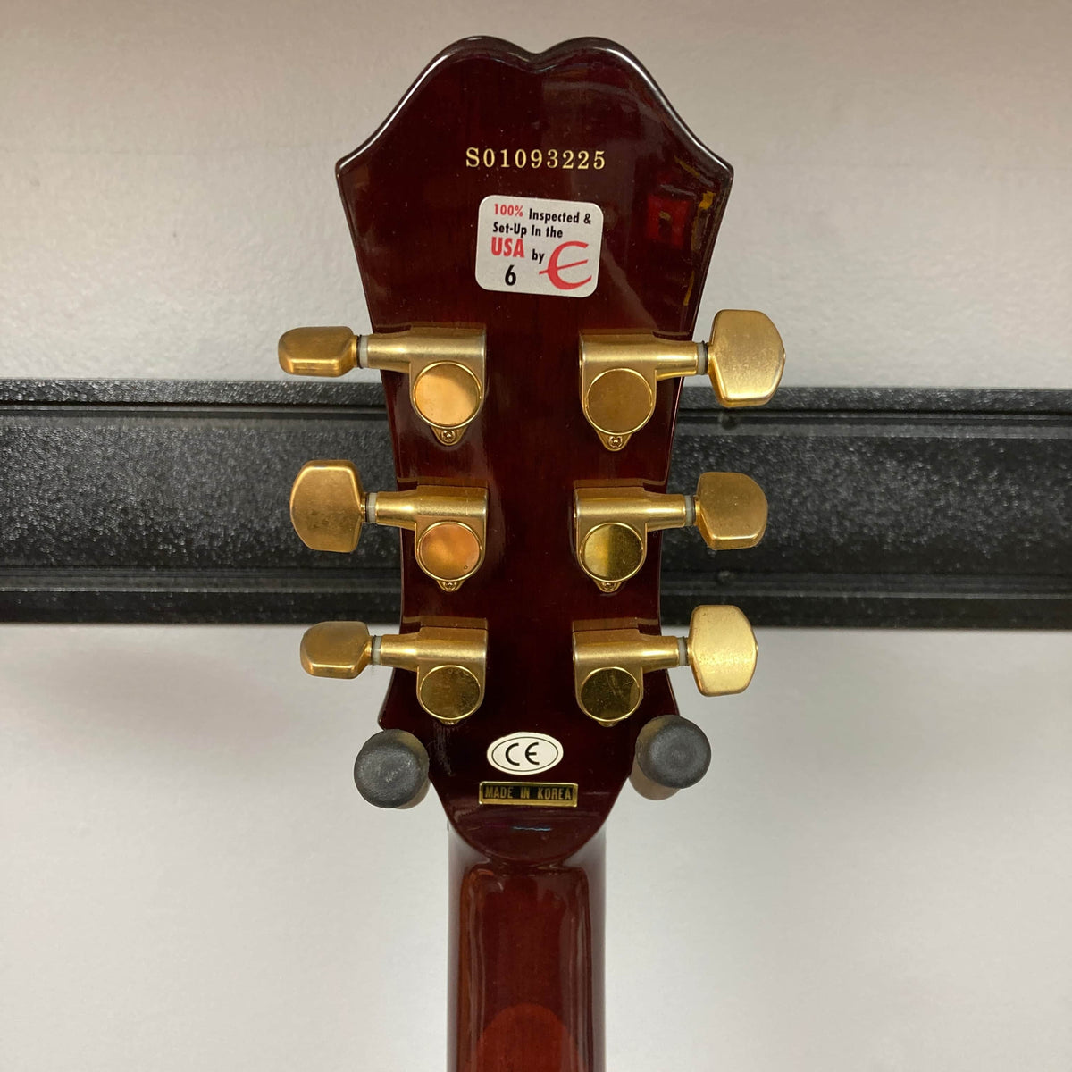 The back of an Epiphone Chet Atkins SST Studio Natural Korea headstock shows gold tuners, serial S01093225, and stickers like "100% Inspected & Setup in the USA." Perfect for feedback-resistant acoustic-electric performance. Includes hard case. Used consignment.