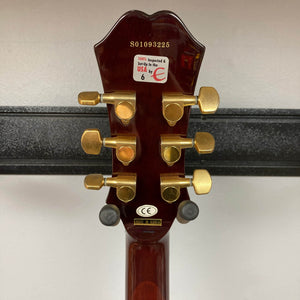 The back of an Epiphone Chet Atkins SST Studio Natural Korea headstock shows gold tuners, serial S01093225, and stickers like "100% Inspected & Setup in the USA." Perfect for feedback-resistant acoustic-electric performance. Includes hard case. Used consignment.