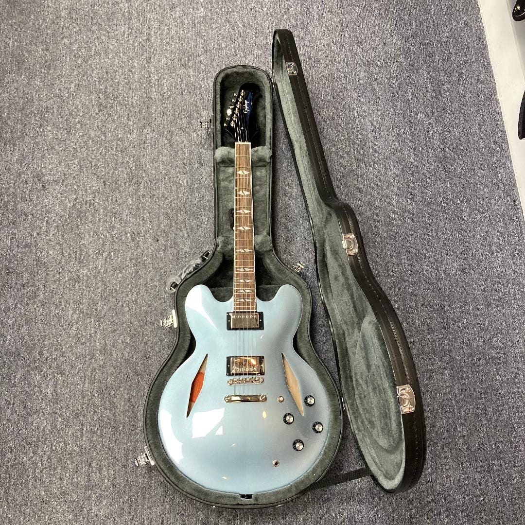Blue Epiphone Dave Grohl DG-335 electric guitar in a hard case, showcasing its craftsmanship and iconic design.