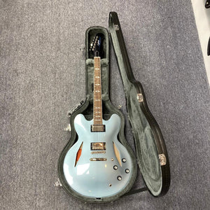 Blue Epiphone Dave Grohl DG-335 electric guitar in a hard case, showcasing its craftsmanship and iconic design.