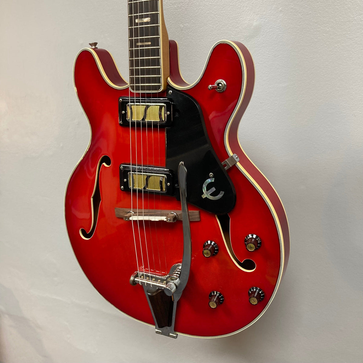Epiphone EA-250 1972-1974 semi-hollow electric guitar with double cutaway body, humbucker pickups, and rosewood fingerboard displayed on a wall.