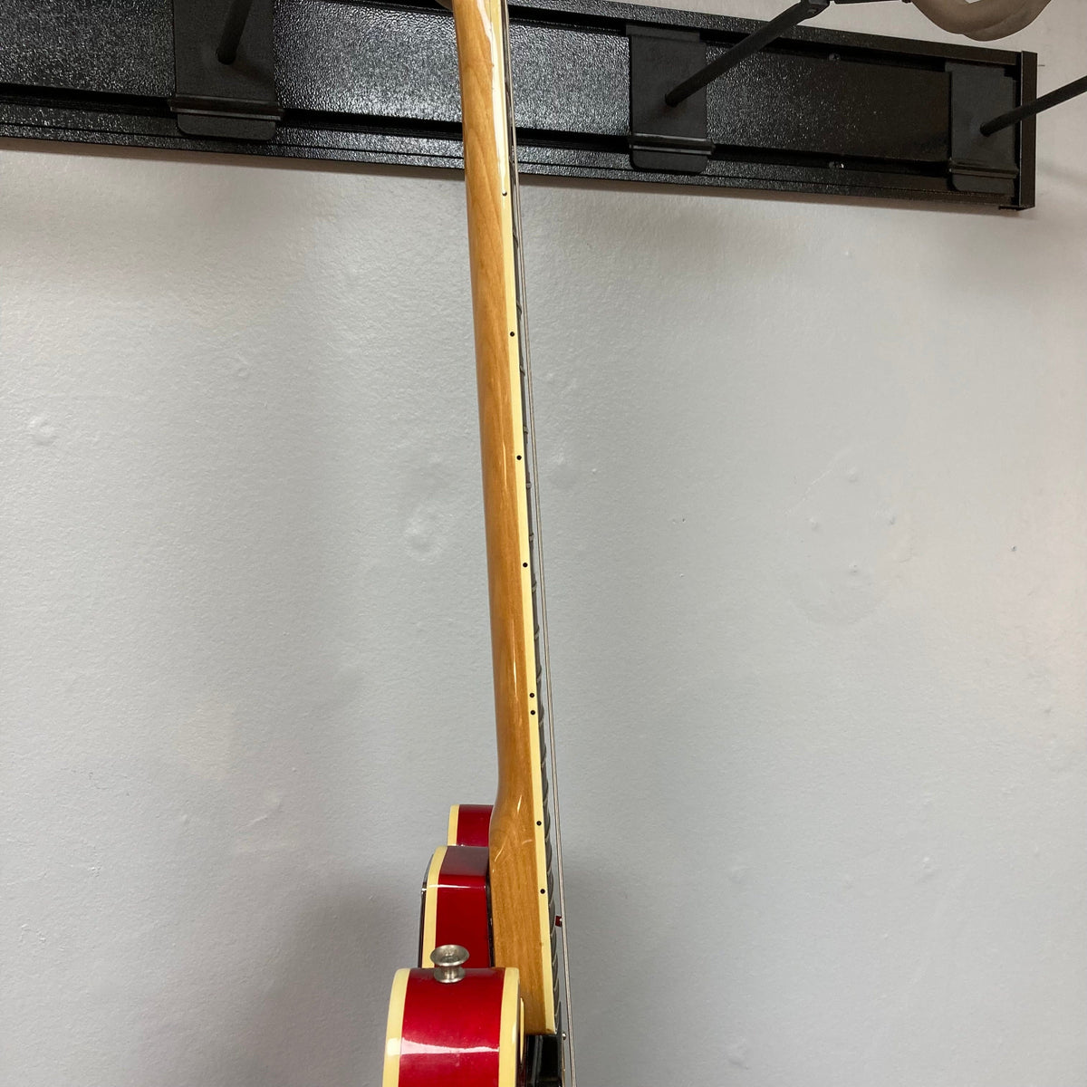Epiphone EA-250 1972-1974 semi-hollow electric guitar leaning against a wall, showcasing its vintage craftsmanship and double cutaway design.