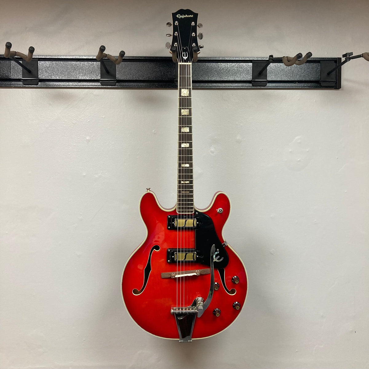 Epiphone EA-250 1972-1974 semi-hollow electric guitar, red, displayed on a wall, showcasing its vintage design and craftsmanship.
