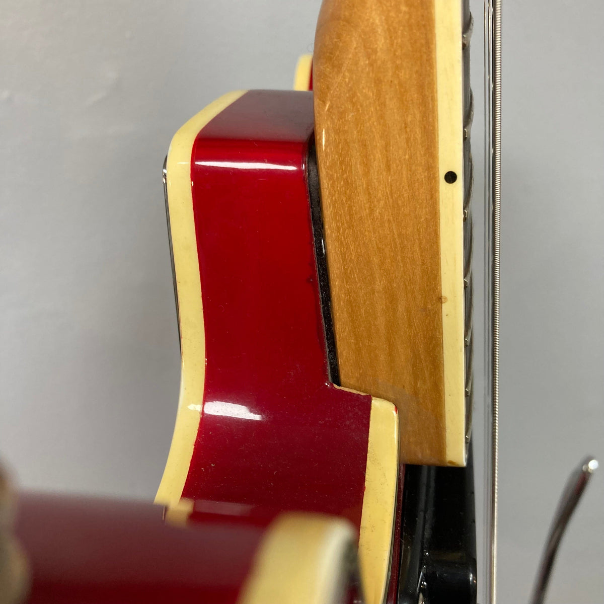 Close-up of an Epiphone EA-250 semi-hollow electric guitar, 1972-1974, showcasing craftsmanship and vintage appeal.