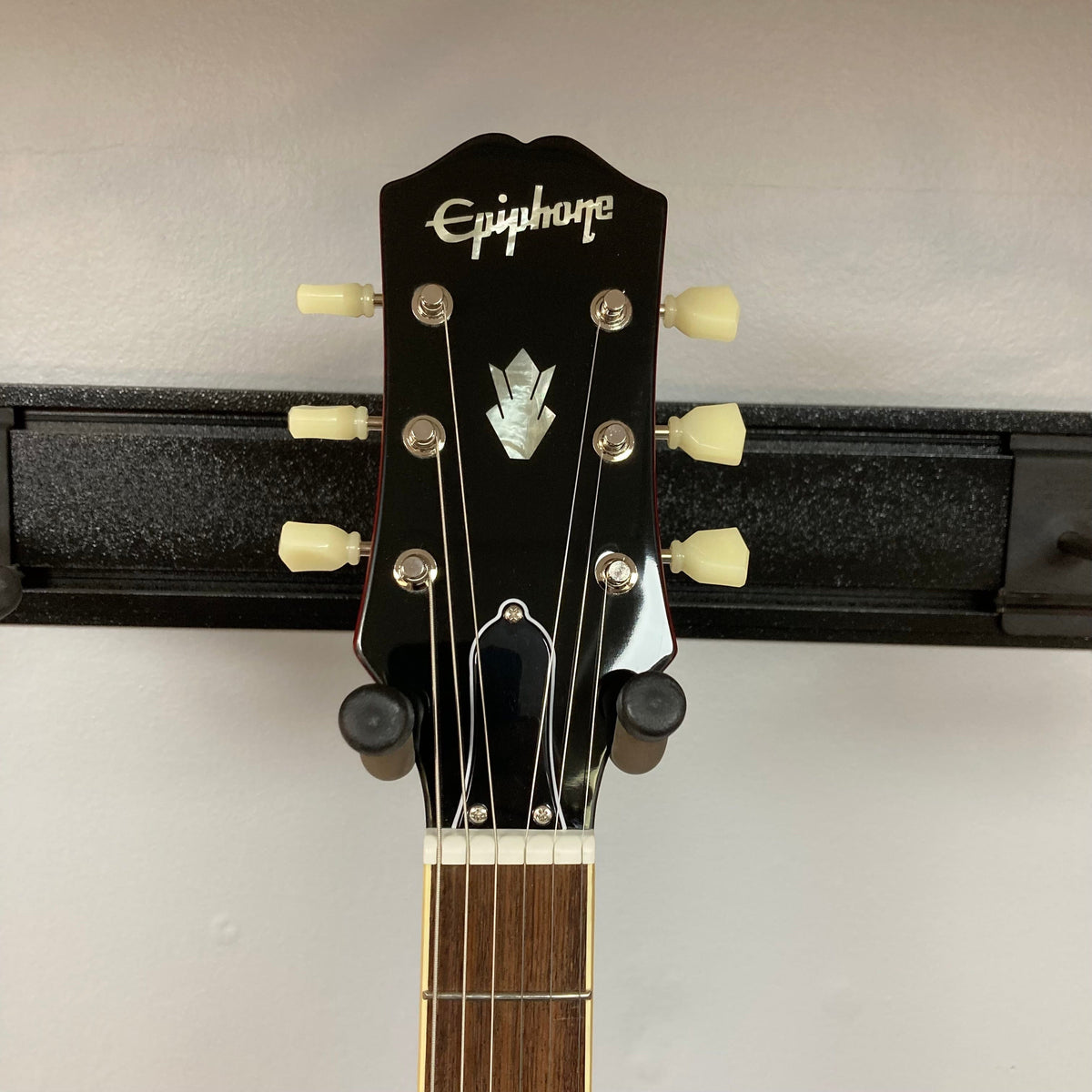 Epiphone ES-335 semi-hollowbody electric guitar on display, showcasing its classic design and craftsmanship with visible strings and fretboard.