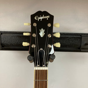 Epiphone ES-335 semi-hollowbody electric guitar on display, showcasing its classic design and craftsmanship with visible strings and fretboard.