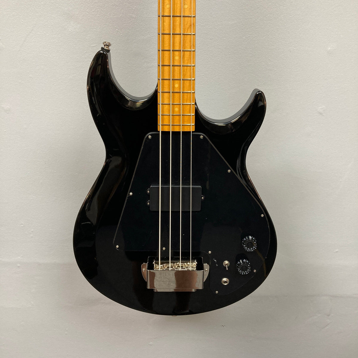 Epiphone Grabber Bass Ebony with yellow neck and brown strings, featuring a maple bolt-on neck, visible humbucker, and controls for versatile playability.