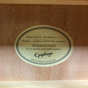 Inside the Epiphone J-45 Studio Vintage Sunburst w/Gigbag, an oval label reads: "Model J-45 Studio, Number 25072300742 is hereby GUARANTEED for its quality and craftsmanship. Epiphone. Handcrafted in Indonesia.
