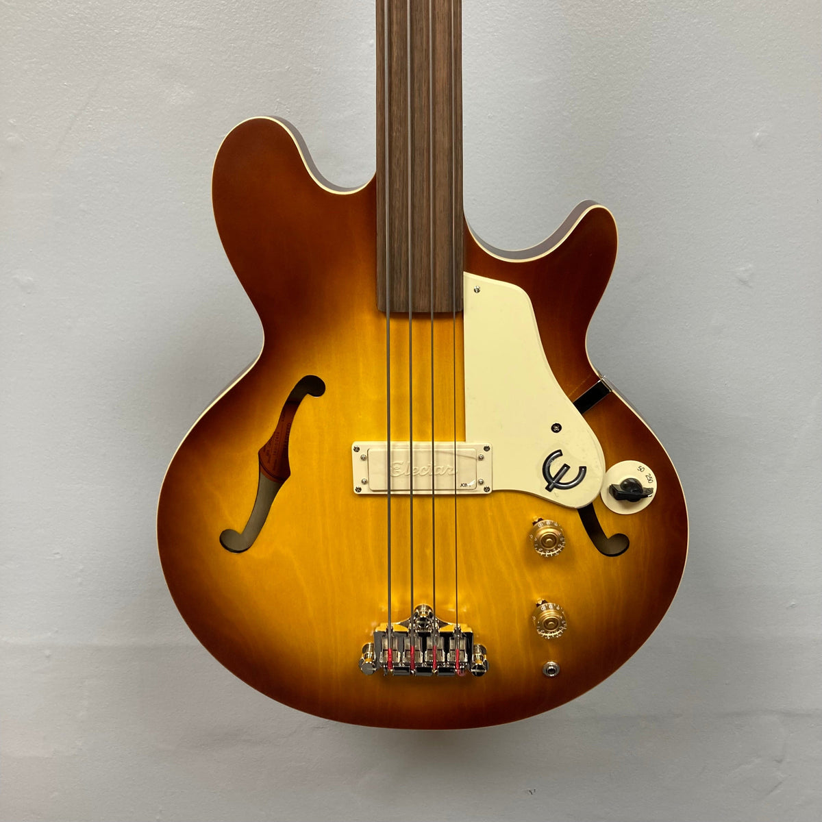 Epiphone Jack Casady Fretless Bass - Aged Royal Tan, showcasing its archtop body, cream binding, and gold speed control knobs, highlighting its superior craftsmanship.