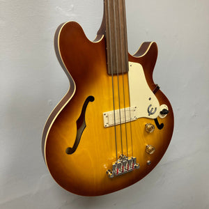 Close-up of the Epiphone Jack Casady Fretless Bass, highlighting the archtop body and tuning machines.