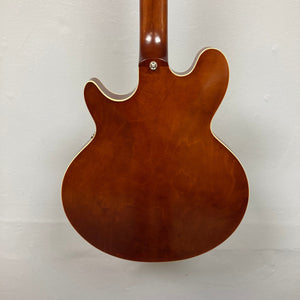 Close-up of the Epiphone Jack Casady Fretless Bass - Aged Royal Tan, showcasing its archtop body, layered maple construction, and intricate hardware details.