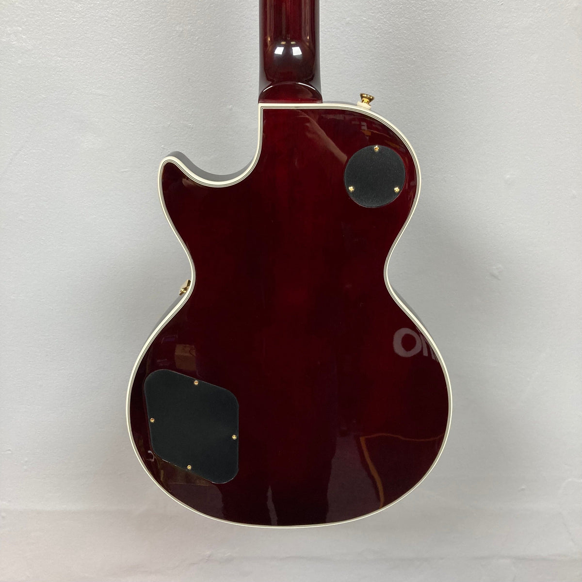 Epiphone Jerry Cantrell Wino Les Paul Custom Wine Red guitar with gold hardware and Grover tuners, featuring a plain maple top and custom hardshell case.