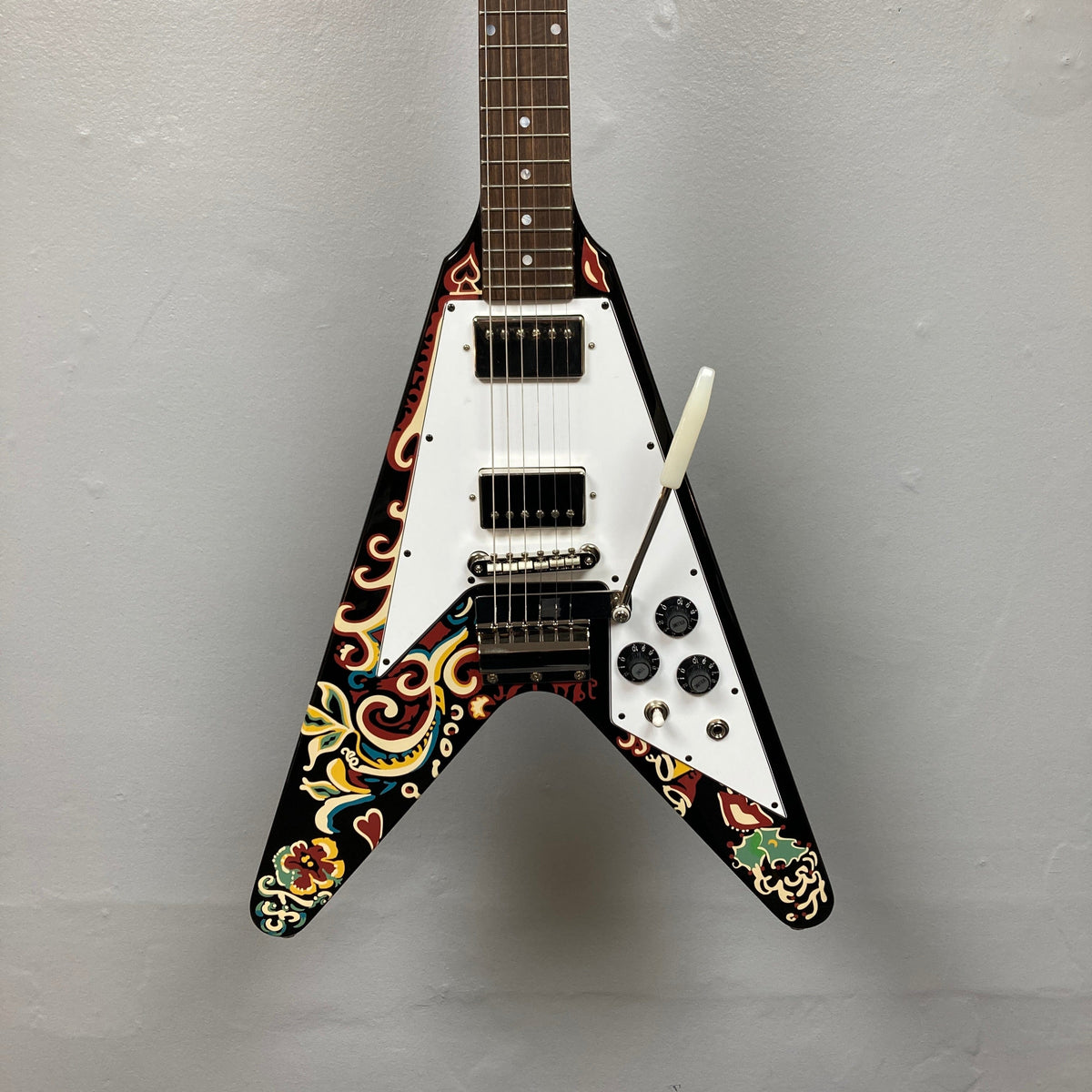 Epiphone Jimi Hendrix Love Drops Flying V guitar, featuring psychedelic design and high-quality craftsmanship, ideal for players and collectors, includes hard case.