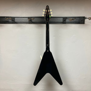 Epiphone Jimi Hendrix Love Drops Flying V guitar, displayed on a wall, showcasing its iconic Flying V design and craftsmanship. Includes hard case.