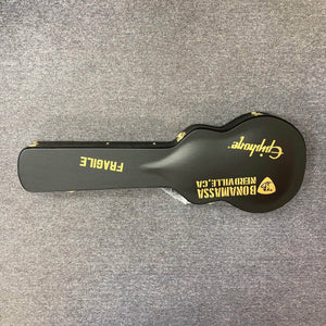 Epiphone Joe Bonamassa 59 Les Paul Custom Bigsby guitar case, black with gold hardware, featuring FRAGILE stencil and custom decal, on gray carpet.