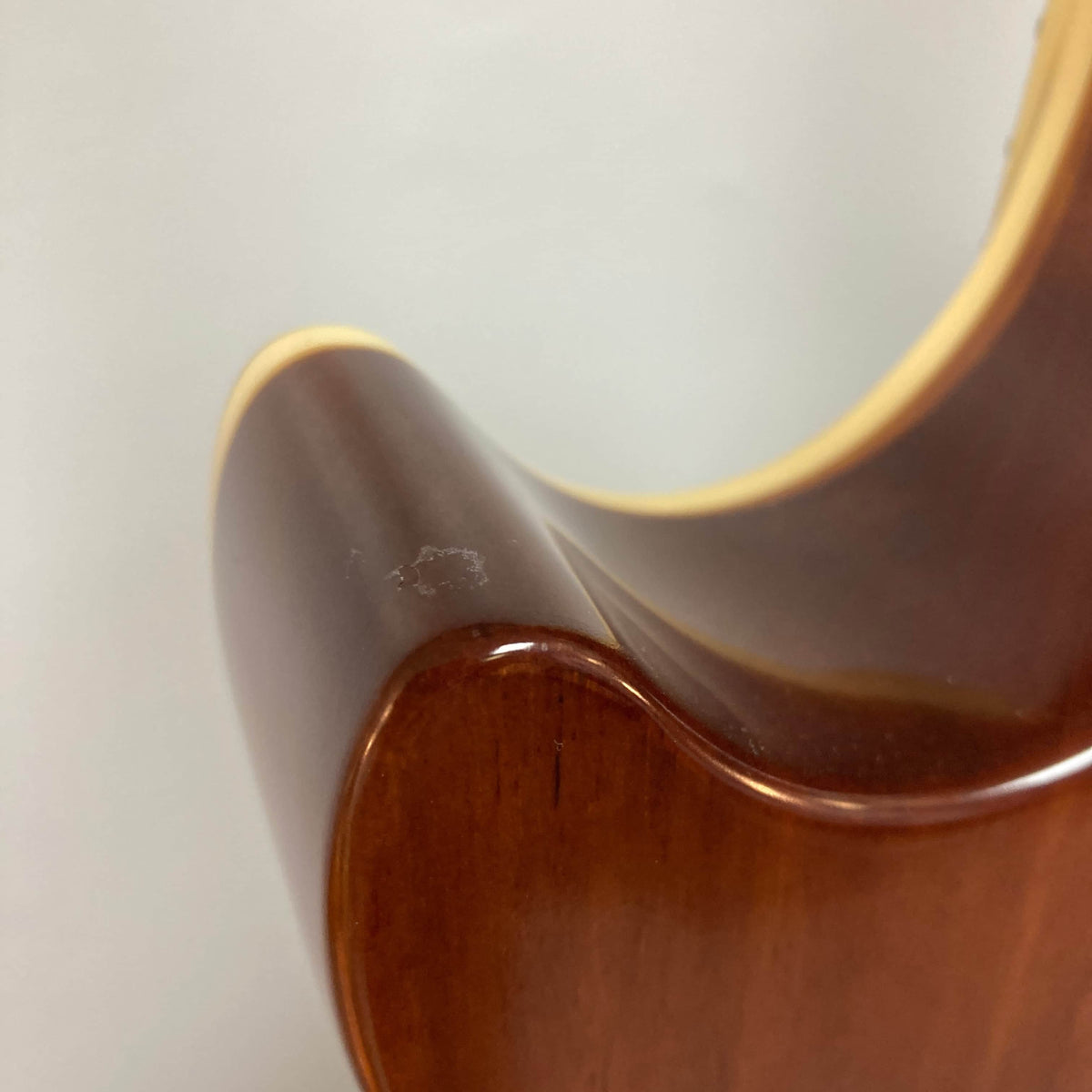 Close-up of the back upper bout of an Epiphone Les Paul 1957 Goldtop Reissue guitar with a small scuff mark near the binding; includes case.