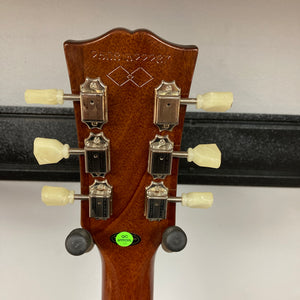 Close-up of an Epiphone Les Paul 1957 Goldtop Reissue Blem headstock, featuring six tuning pegs, serial number, decorative inlay, and a green "QC approved" sticker on the back—evoking classic Goldtop style.