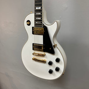 Epiphone Les Paul Custom Inspired by Gibson Alpine White electric guitar with gold hardware, ebony fretboard, and included hardshell case.