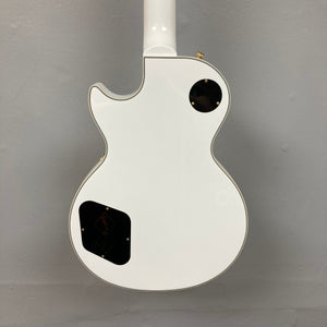 Epiphone Les Paul Custom Inspired by Gibson Alpine White guitar with black dots, gold hardware, and ebony fretboard, showcased with a hardshell case.