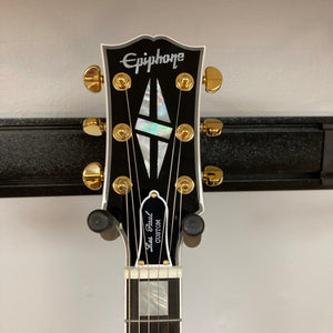 Close-up of the Epiphone Les Paul Custom Inspired by Gibson Ebony w/Case, highlighting its neck, strings, and signature hardware details.